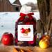 Irish Twins Apple Cinnamon Potpourri sitting on a wooden table dusted with snow next to apples and cinnamon sticks.